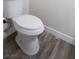 Clean bathroom featuring a white toilet and modern wood-look flooring at 223 Greenbriar Townhouse Way, Las Vegas, NV 89121