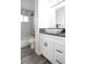 This updated bathroom features a modern vanity with white cabinets and a black faucet at 223 Greenbriar Townhouse Way, Las Vegas, NV 89121