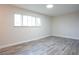 Spacious bedroom with natural light, modern flooring, and minimalist design at 223 Greenbriar Townhouse Way, Las Vegas, NV 89121
