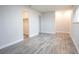 Bright, open bedroom featuring wood-look flooring, neutral walls, and closet space at 223 Greenbriar Townhouse Way, Las Vegas, NV 89121