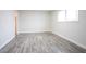 Neutral bedroom with wood-look floors, natural lighting, and a closet space at 223 Greenbriar Townhouse Way, Las Vegas, NV 89121
