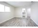 Bright bedroom features laminate flooring, base trim and natural light at 223 Greenbriar Townhouse Way, Las Vegas, NV 89121