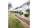 Exterior view of townhome showcasing maintained landscaping and walkway at 223 Greenbriar Townhouse Way, Las Vegas, NV 89121