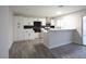Kitchen with new white cabinets, black hardware, and wood laminate floors at 223 Greenbriar Townhouse Way, Las Vegas, NV 89121