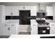 Kitchen with new white cabinets, stainless steel appliances, and wood laminate floors at 223 Greenbriar Townhouse Way, Las Vegas, NV 89121