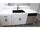 Kitchen island featuring white cabinets, a black sink, and stainless steel dishwasher at 223 Greenbriar Townhouse Way, Las Vegas, NV 89121