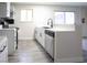 Kitchen with new white cabinets, black hardware, and stainless steel dishwasher at 223 Greenbriar Townhouse Way, Las Vegas, NV 89121