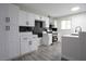 Bright kitchen with white cabinets, stainless steel appliances, and wood laminate floors at 223 Greenbriar Townhouse Way, Las Vegas, NV 89121