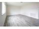 Living room with gray wood laminate flooring and large window at 223 Greenbriar Townhouse Way, Las Vegas, NV 89121