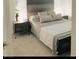 Modern bedroom featuring gray-toned decor, stylish nightstands, and plush carpeting at 2379 Albury Ave, North Las Vegas, NV 89086