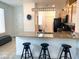 Bright kitchen features granite counters, stainless appliances, and breakfast bar with three stools at 2379 Albury Ave, North Las Vegas, NV 89086