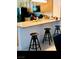 View of the kitchen with breakfast bar and seating and granite countertops at 2379 Albury Ave, North Las Vegas, NV 89086