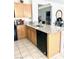Charming kitchen with light wood cabinets, granite countertops, black appliances and tiled flooring at 2379 Albury Ave, North Las Vegas, NV 89086