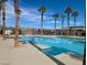 Relax in the pool surrounded by lush landscaping and palm trees at 2379 Albury Ave, North Las Vegas, NV 89086