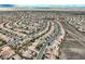 Expansive aerial view of a residential community with curving streets and mountain views at 2388 Orangeburg Pl, Henderson, NV 89044
