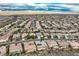 Expansive aerial view showcasing a community of tile-roofed homes in a desert setting at 2388 Orangeburg Pl, Henderson, NV 89044