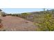 Spacious backyard with gravel landscaping, a wrought-iron fence, and views of the scenic hills at 2388 Orangeburg Pl, Henderson, NV 89044