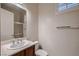 Bathroom with a wood vanity, solid surface countertop, and shower/tub combo at 2388 Orangeburg Pl, Henderson, NV 89044