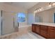 Bathroom featuring a large window, soaking tub, separate shower, and double vanity at 2388 Orangeburg Pl, Henderson, NV 89044