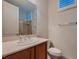 Bathroom featuring a wood vanity, solid surface countertop, and shower/tub combo at 2388 Orangeburg Pl, Henderson, NV 89044