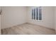 A bright bedroom features wood-look flooring and a window with white shutters at 2388 Orangeburg Pl, Henderson, NV 89044