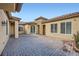 Spacious courtyard with brick pavers, stucco walls, and arched entryways at 2388 Orangeburg Pl, Henderson, NV 89044