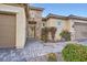 Beautiful home exterior with a decorative metal gate, stone accents, and desert-friendly landscaping at 2388 Orangeburg Pl, Henderson, NV 89044