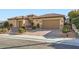 Attractive home with a brick driveway, well-maintained landscaping, and a three-car garage at 2388 Orangeburg Pl, Henderson, NV 89044