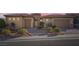 Charming single-story home with desert landscaping, brick driveway, and two-car garage at 2388 Orangeburg Pl, Henderson, NV 89044