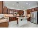 Spacious kitchen features custom wood cabinets, granite countertops, and stainless steel appliances at 2388 Orangeburg Pl, Henderson, NV 89044