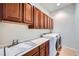 Well-organized laundry room with a sink, cabinets and a modern washer and dryer at 2388 Orangeburg Pl, Henderson, NV 89044