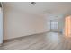 Open living room with wood-look flooring, neutral paint and a ceiling fan at 2388 Orangeburg Pl, Henderson, NV 89044