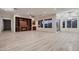 Bright living room features a fireplace, built-in shelving, large windows, and light wood-look flooring at 2388 Orangeburg Pl, Henderson, NV 89044