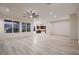 Large, open living room with wood-look flooring, mountain views, and recessed lighting at 2388 Orangeburg Pl, Henderson, NV 89044