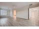 Spacious living room with wood-look flooring, fan, and lots of natural light at 2388 Orangeburg Pl, Henderson, NV 89044