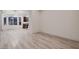 Spacious living room with wood-look flooring, mountain views, and access to the kitchen at 2388 Orangeburg Pl, Henderson, NV 89044