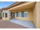 Covered outdoor patio featuring a smooth concrete surface, stucco walls, and sliding glass doors at 2388 Orangeburg Pl, Henderson, NV 89044