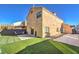 Backyard with artificial turf, seating area, gravel area, and back exterior of home at 4125 Glenfield Cir, Las Vegas, NV 89129