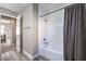 Modern bathroom with a shower-tub combination and a door leading to the bedroom at 4125 Glenfield Cir, Las Vegas, NV 89129