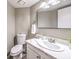 Bright bathroom features white marble counters, large mirror, and a white toilet at 4125 Glenfield Cir, Las Vegas, NV 89129