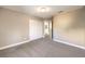 Spacious bedroom with neutral carpet, double closet, and access to the ensuite bathroom at 4125 Glenfield Cir, Las Vegas, NV 89129