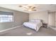 Comfortable bedroom with soft carpeting, a ceiling fan, and a window providing natural light at 4125 Glenfield Cir, Las Vegas, NV 89129