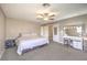 Well-lit bedroom featuring soft carpeting, a ceiling fan, and a vanity area with great lighting at 4125 Glenfield Cir, Las Vegas, NV 89129
