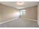 Bright, empty bedroom with neutral carpet, and window ready for your personal touch at 4125 Glenfield Cir, Las Vegas, NV 89129