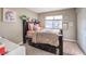 Cozy bedroom with plush decor, a dark wood bed frame, and a view to the window at 4125 Glenfield Cir, Las Vegas, NV 89129