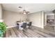 Cozy dining area with modern flooring, a stylish table setting, and views into the living space at 4125 Glenfield Cir, Las Vegas, NV 89129