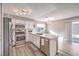 Bright kitchen featuring stainless steel appliances, white cabinets, and a breakfast bar at 4125 Glenfield Cir, Las Vegas, NV 89129