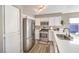 Clean kitchen showcasing stainless steel appliances, white cabinetry, and wood-look floors at 4125 Glenfield Cir, Las Vegas, NV 89129