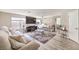 Spacious living room featuring modern flooring, plush seating, a large TV, and stylish decor at 4125 Glenfield Cir, Las Vegas, NV 89129