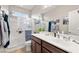 Bathroom featuring a walk-in shower with glass doors and a vanity with modern fixtures at 4459 Lavender, Pahrump, NV 89061